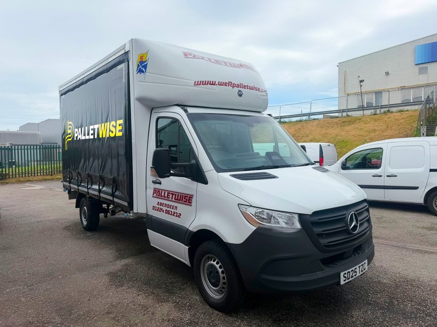 Palletwise delivery van parked outside a warehouse